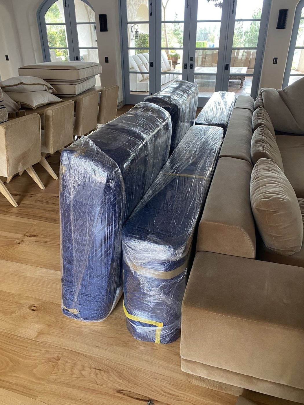 Blanket-wrapped and stretch-wrapped furniture ready to move inside a home
