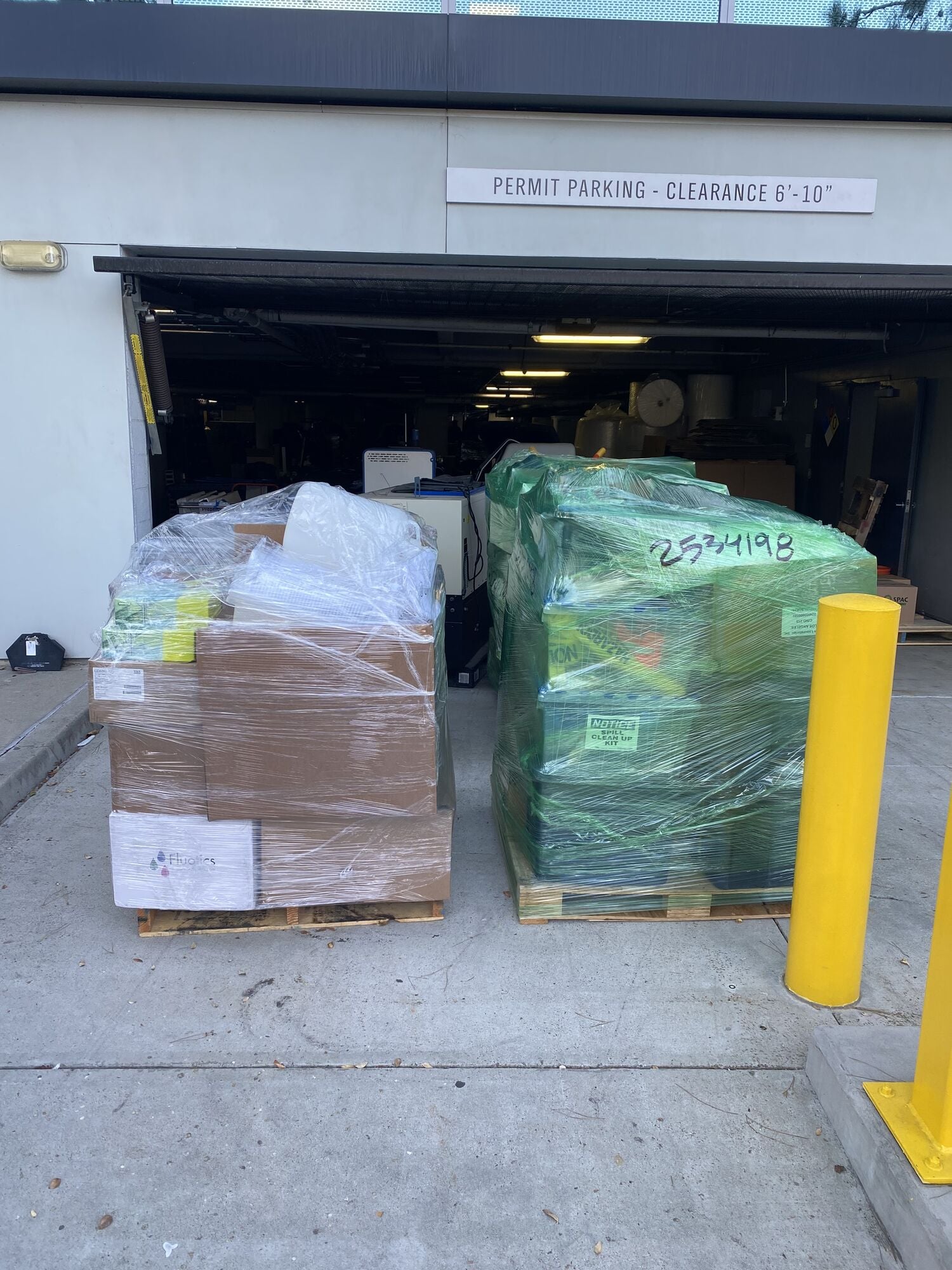 Stretch-wrapped pallets of freight at a loading dock, ready for delivery